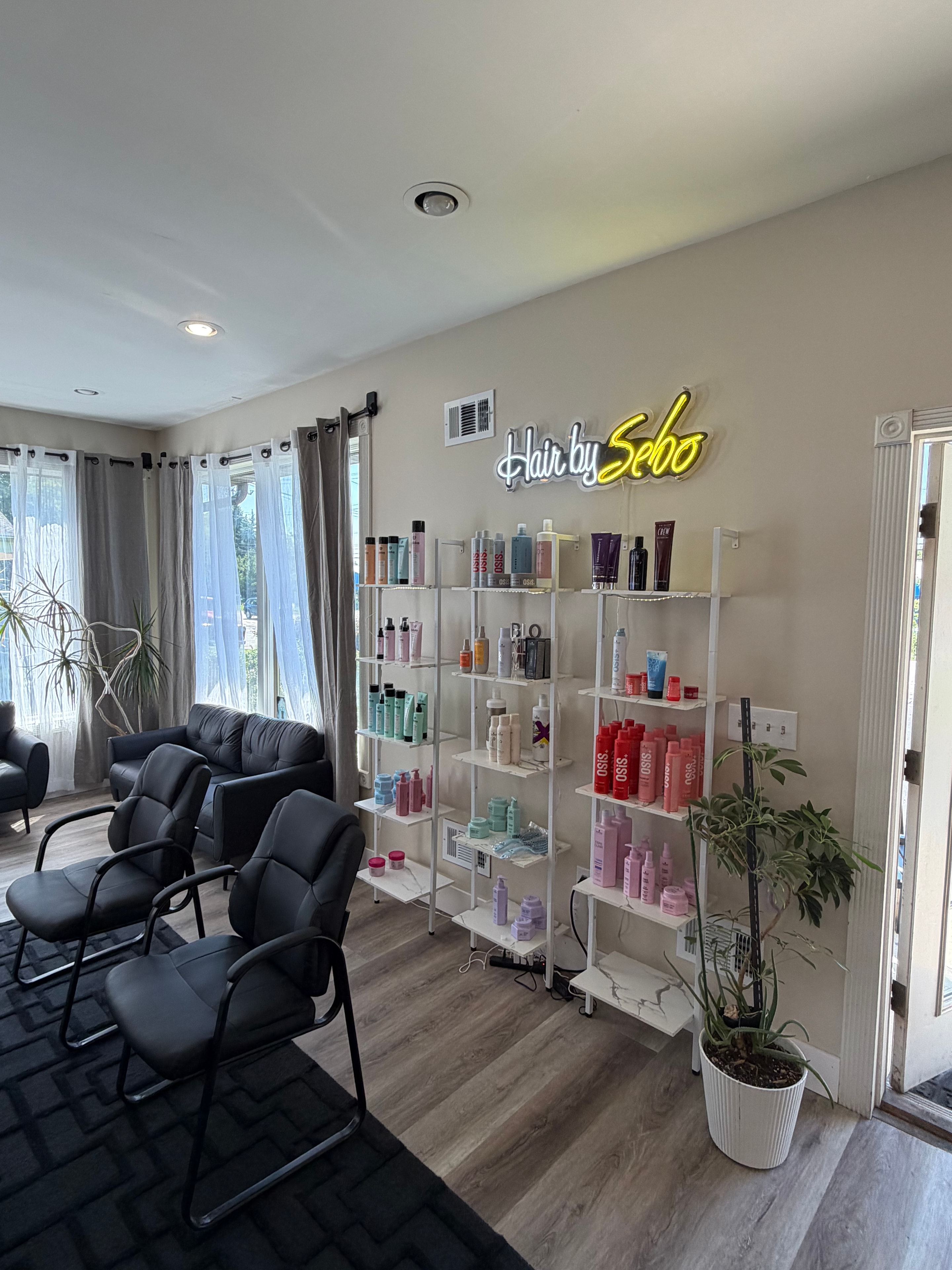 Hair by Sebo neon sign and product shelving display